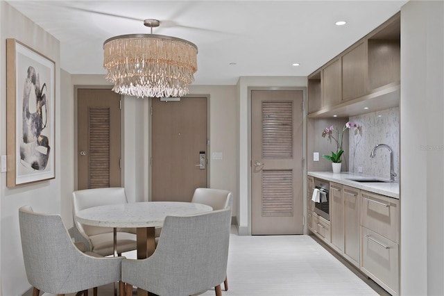 dining area featuring a notable chandelier and sink