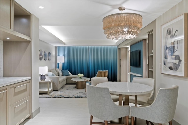 dining room with a chandelier and built in shelves