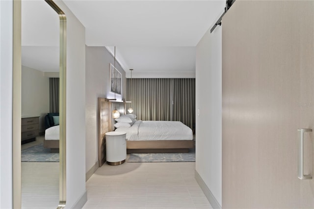 tiled bedroom featuring a barn door