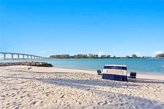 exterior space featuring a water view and a beach view