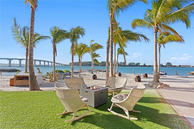 view of nearby features with an outdoor fire pit, a water view, and a yard