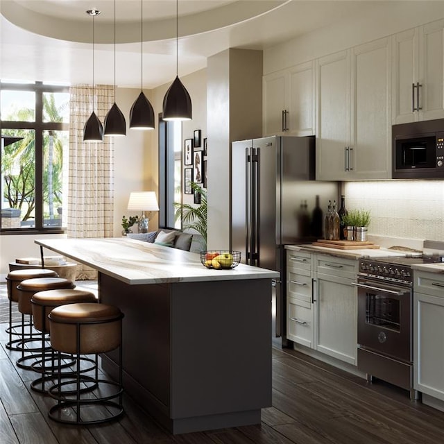 kitchen featuring a center island, black microwave, white cabinetry, hanging light fixtures, and electric range oven