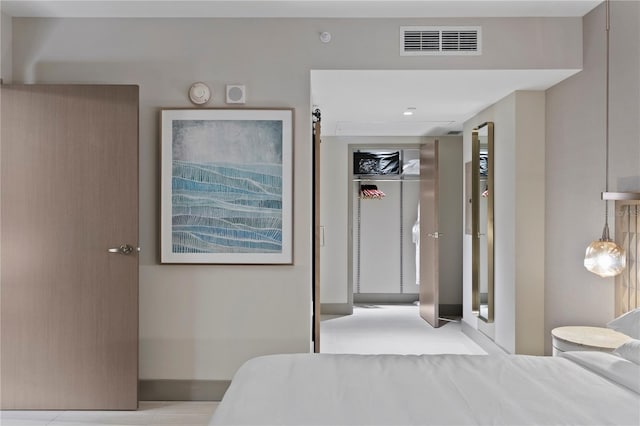 bedroom with a closet and light tile floors