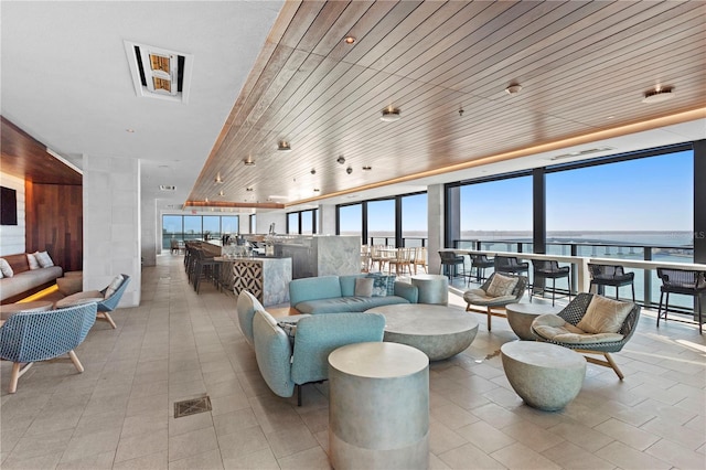 living room with wood ceiling and light tile floors