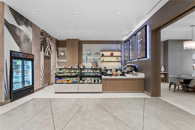 interior space with light tile floors, hanging light fixtures, and a chandelier