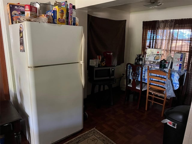 kitchen with white refrigerator and parquet floors