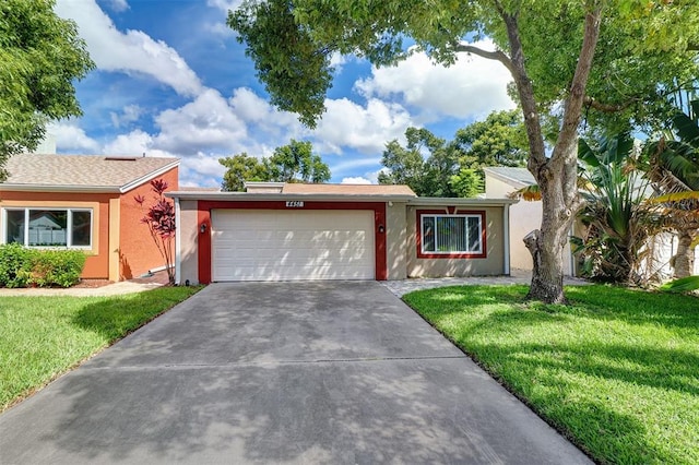 ranch-style house featuring a front yard and a garage