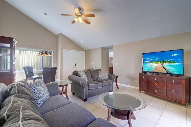 tiled living room featuring high vaulted ceiling and ceiling fan with notable chandelier