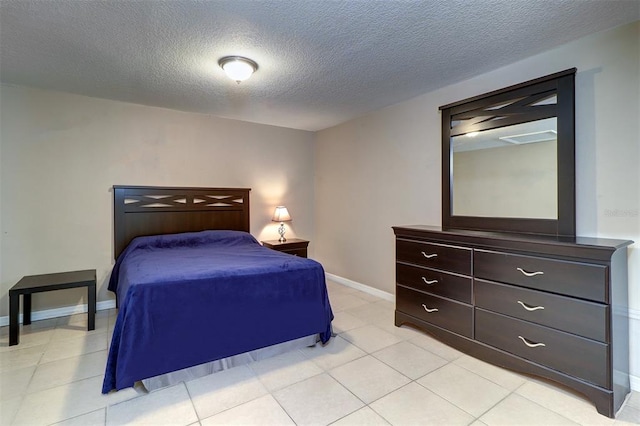 bedroom featuring a textured ceiling and light tile flooring