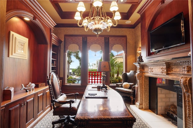 office area featuring built in shelves, a premium fireplace, crown molding, and a chandelier