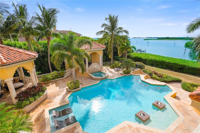 view of swimming pool with a patio area, an in ground hot tub, and a water view