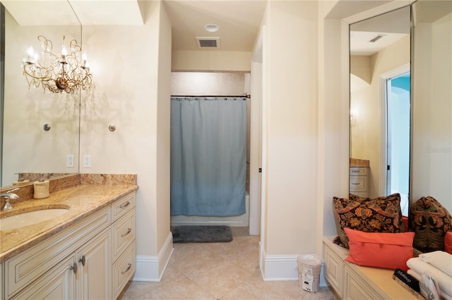 bathroom with tile patterned floors, vanity, shower / bath combo, and an inviting chandelier