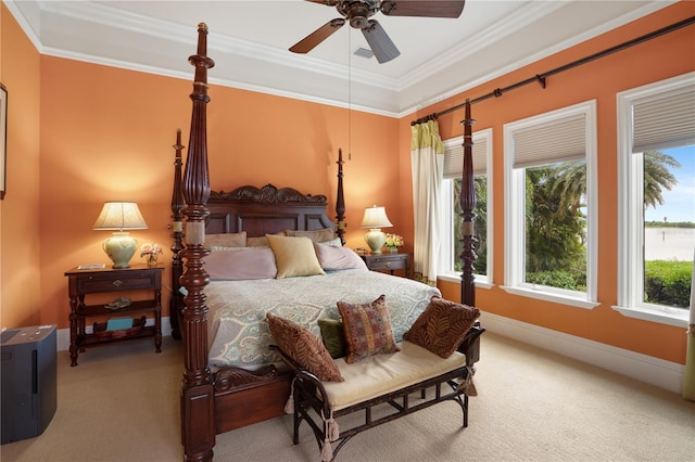 carpeted bedroom with ceiling fan and ornamental molding