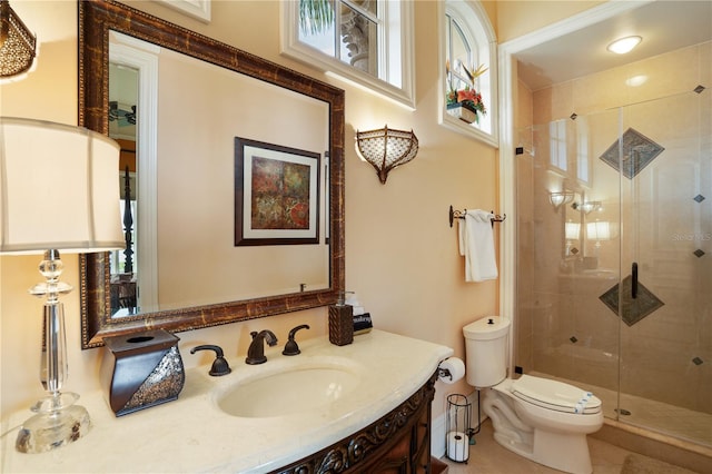 bathroom with vanity, toilet, and an enclosed shower