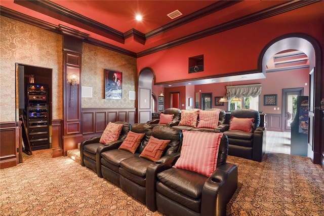 carpeted cinema room featuring ornamental molding