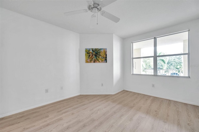 spare room with light hardwood / wood-style floors and ceiling fan