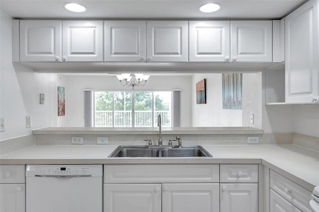 kitchen with an inviting chandelier, white cabinetry, sink, and white dishwasher