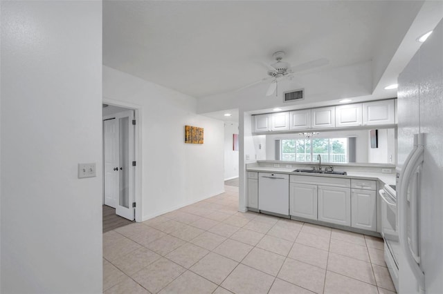 kitchen featuring white appliances, ceiling fan, sink, and light tile floors