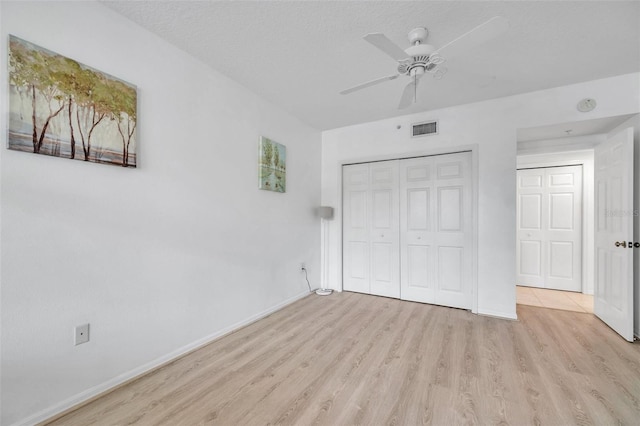 unfurnished bedroom with light hardwood / wood-style floors and ceiling fan