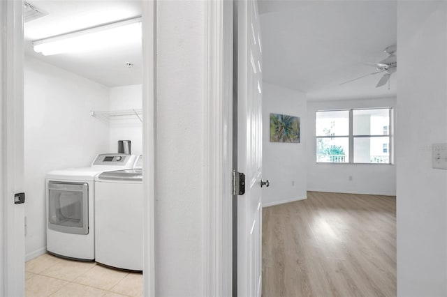 laundry room with ceiling fan, separate washer and dryer, and light tile floors