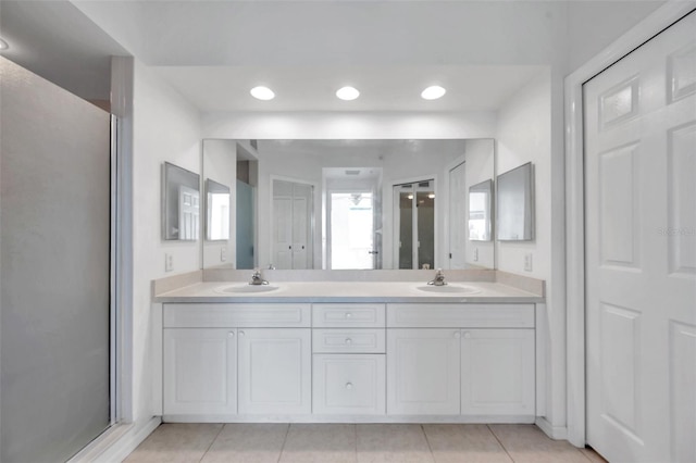 bathroom with double sink, oversized vanity, and tile floors