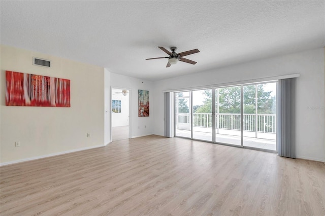 spare room with light hardwood / wood-style flooring, ceiling fan, and a textured ceiling