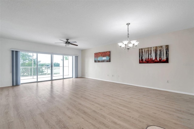 empty room with light hardwood / wood-style flooring, a textured ceiling, and ceiling fan with notable chandelier