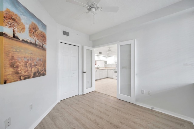 tiled bedroom featuring ceiling fan and sink