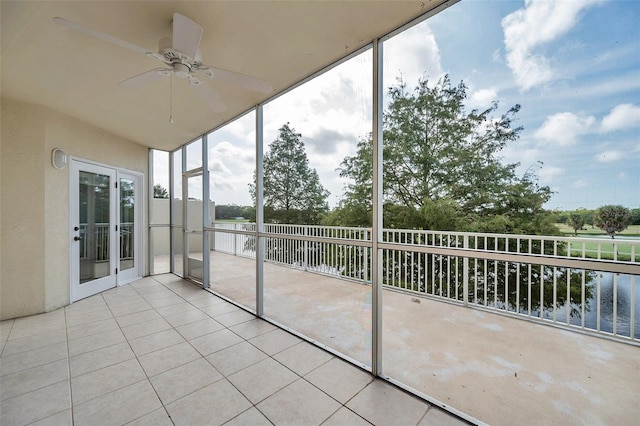 unfurnished sunroom with french doors and ceiling fan