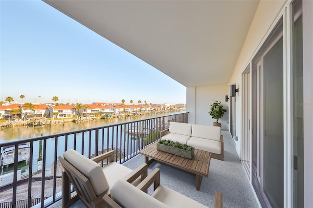 balcony featuring a water view and outdoor lounge area