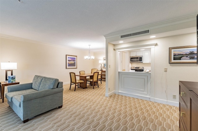 living area featuring baseboards, visible vents, and crown molding