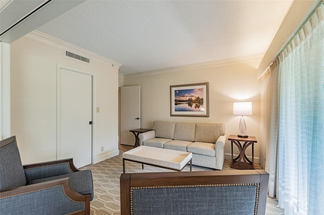 living area featuring a textured ceiling, ornamental molding, and visible vents