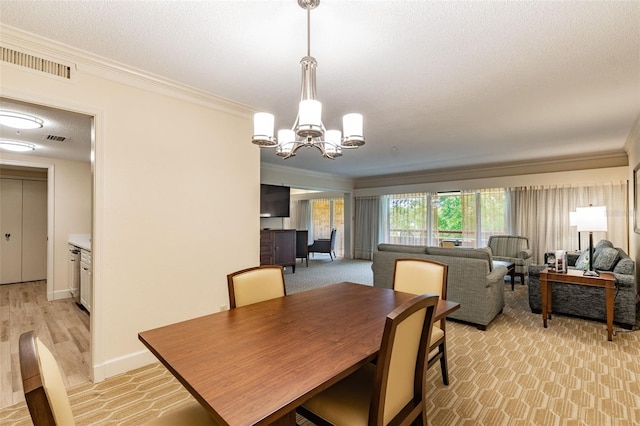 dining area with a chandelier, ornamental molding, a textured ceiling, and visible vents