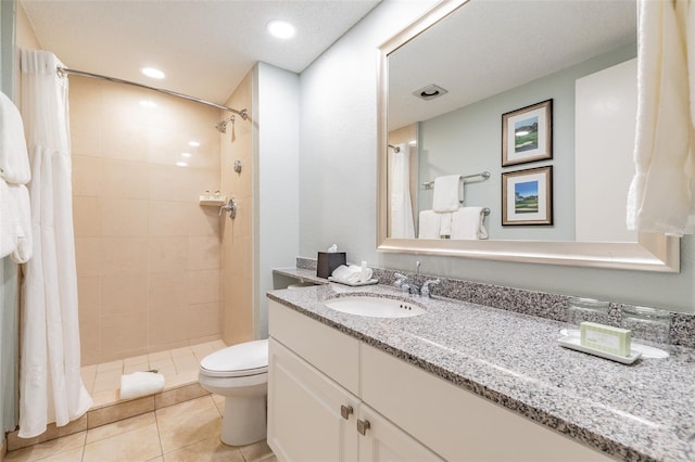 bathroom featuring toilet, tile patterned floors, vanity, a shower stall, and recessed lighting