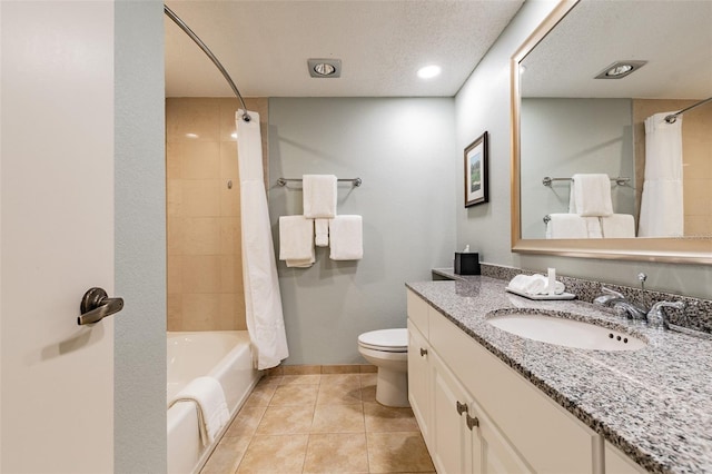 bathroom with tile patterned flooring, toilet, vanity, baseboards, and shower / bath combination with curtain