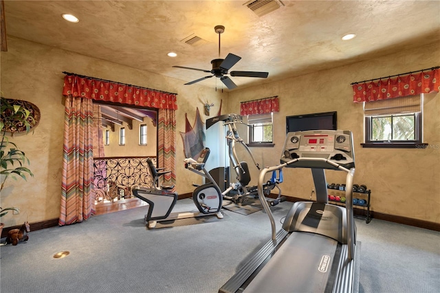 exercise room featuring ceiling fan and carpet flooring