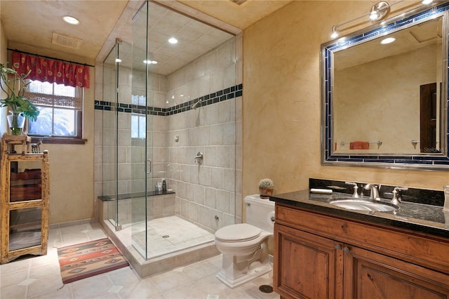 bathroom with an enclosed shower, vanity, tile patterned flooring, and toilet