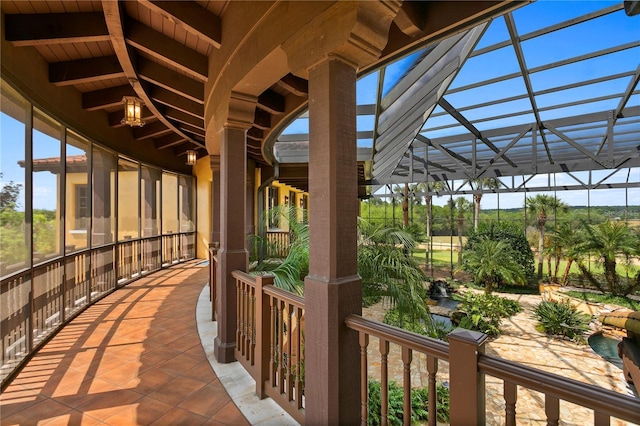 view of patio featuring glass enclosure