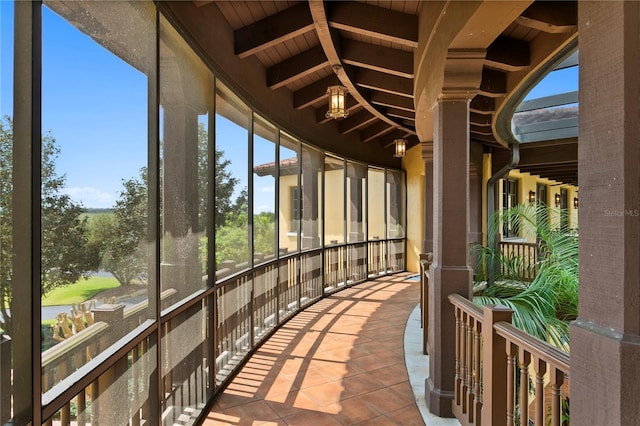 exterior space featuring wooden ceiling and vaulted ceiling with beams