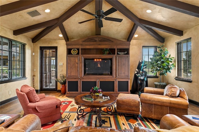 living room featuring ceiling fan, vaulted ceiling with beams, and hardwood / wood-style floors