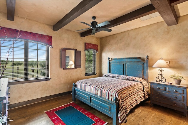 bedroom with ceiling fan, dark hardwood / wood-style flooring, and beam ceiling