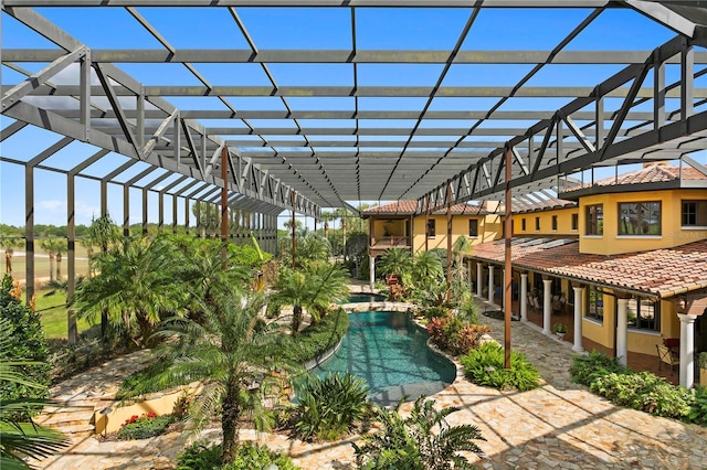 view of swimming pool featuring a lanai