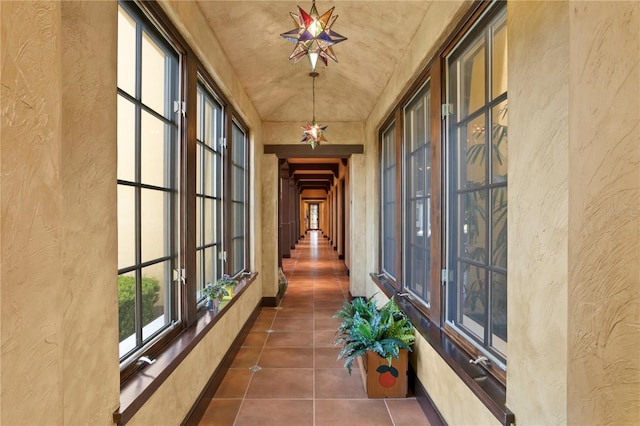 hall featuring dark tile patterned flooring