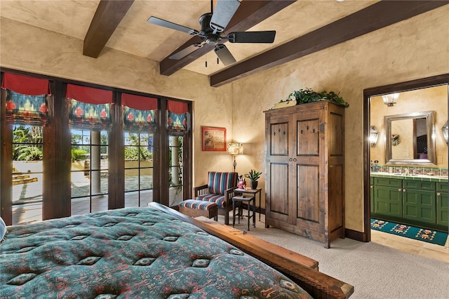 bedroom featuring ceiling fan, carpet flooring, connected bathroom, and beamed ceiling