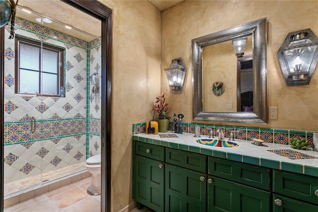 bathroom featuring toilet, vanity, and tile patterned flooring