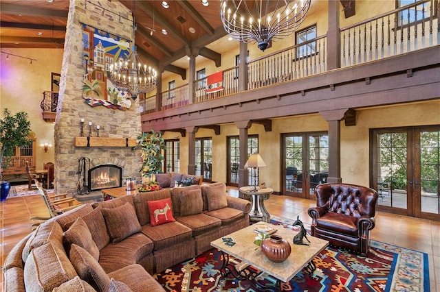 tiled living room with a towering ceiling, wood ceiling, ornate columns, french doors, and beam ceiling