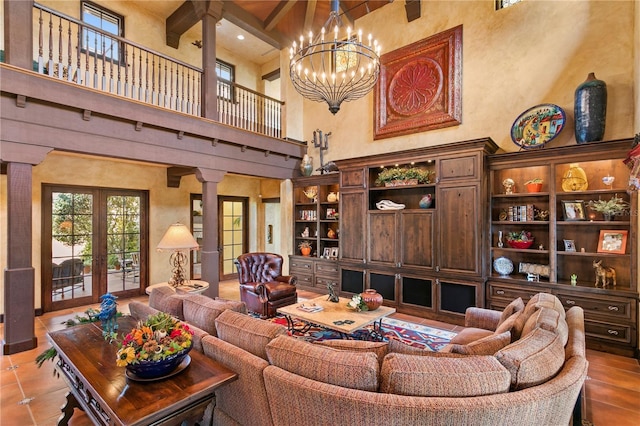 tiled living room with an inviting chandelier, decorative columns, a towering ceiling, french doors, and beamed ceiling