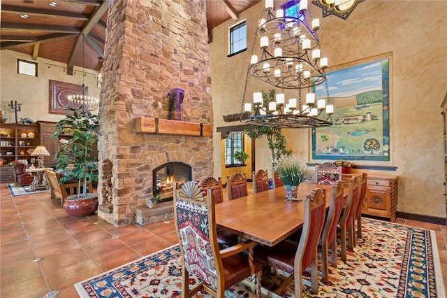 tiled dining room featuring beam ceiling, wood ceiling, a fireplace, and high vaulted ceiling