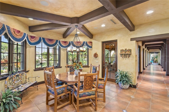 tiled dining space featuring a notable chandelier and beamed ceiling