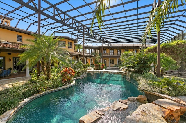 view of swimming pool featuring a lanai